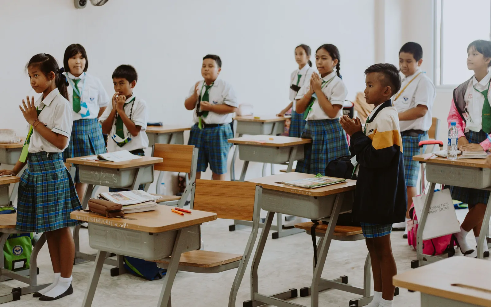 Students in school uniforms attending a classroom lecture