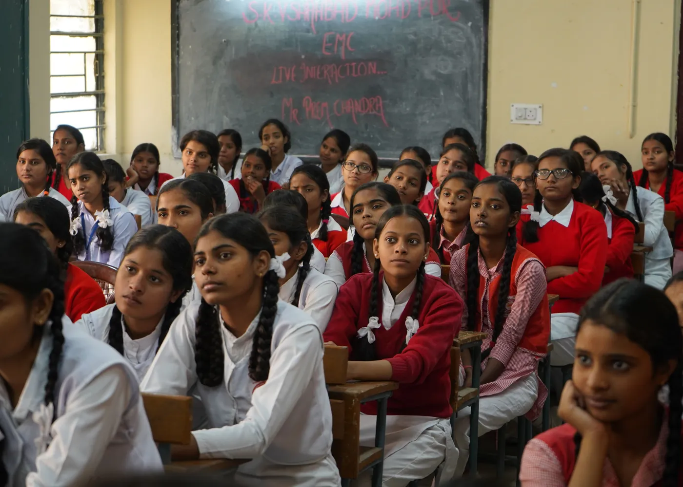 South Asian schoolgirls listening attentively in a classroom