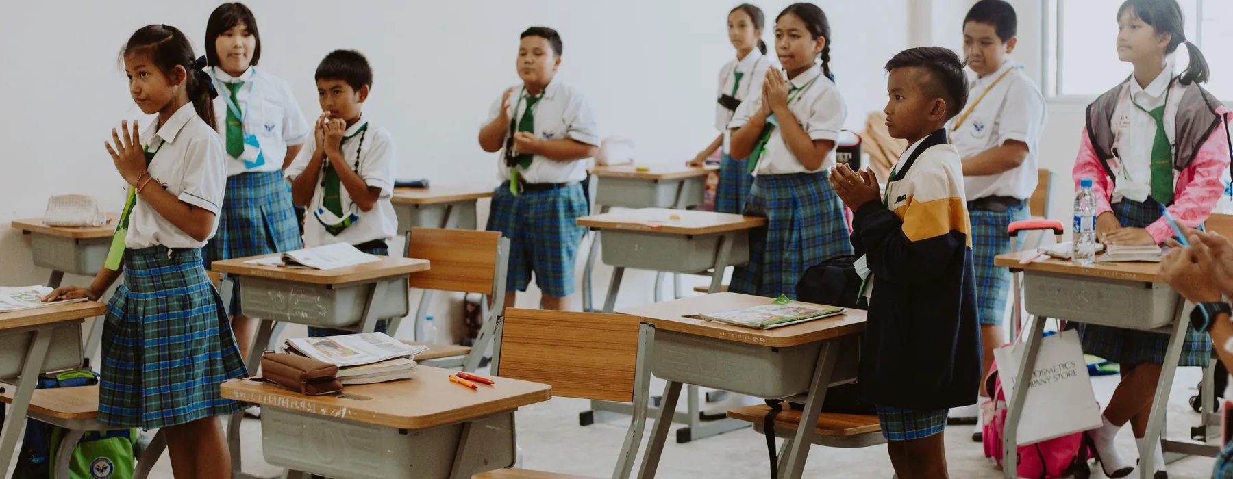 Students in school uniforms learning together in a bright classroom