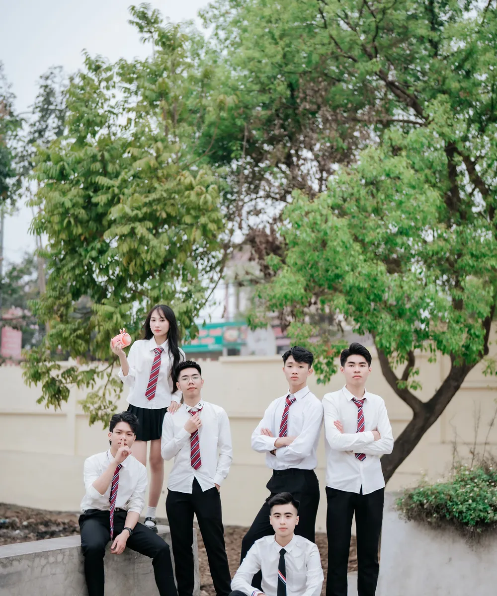 A group of uniformed students standing outdoors at school